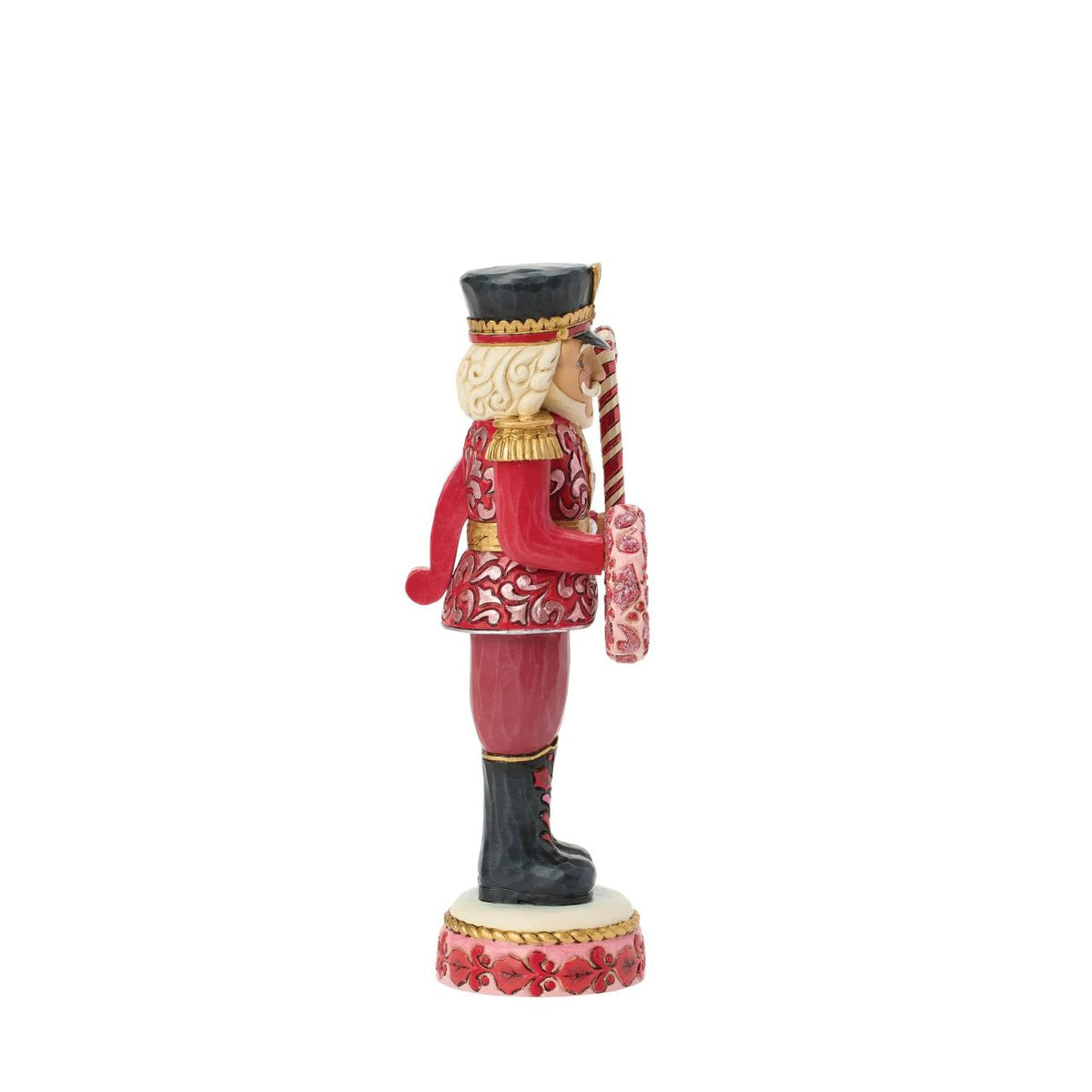 This Toy Soldier nutcracker is smartly dressed in crisp red and white with golden accents. Jim Shore's signature folk-art patterns add warmth and personality to the disciplined stance, making it a playful yet elegant holiday accent.
