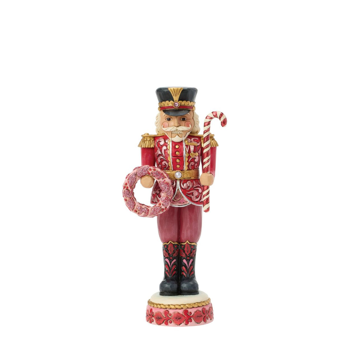 This Toy Soldier nutcracker is smartly dressed in crisp red and white with golden accents. Jim Shore's signature folk-art patterns add warmth and personality to the disciplined stance, making it a playful yet elegant holiday accent.