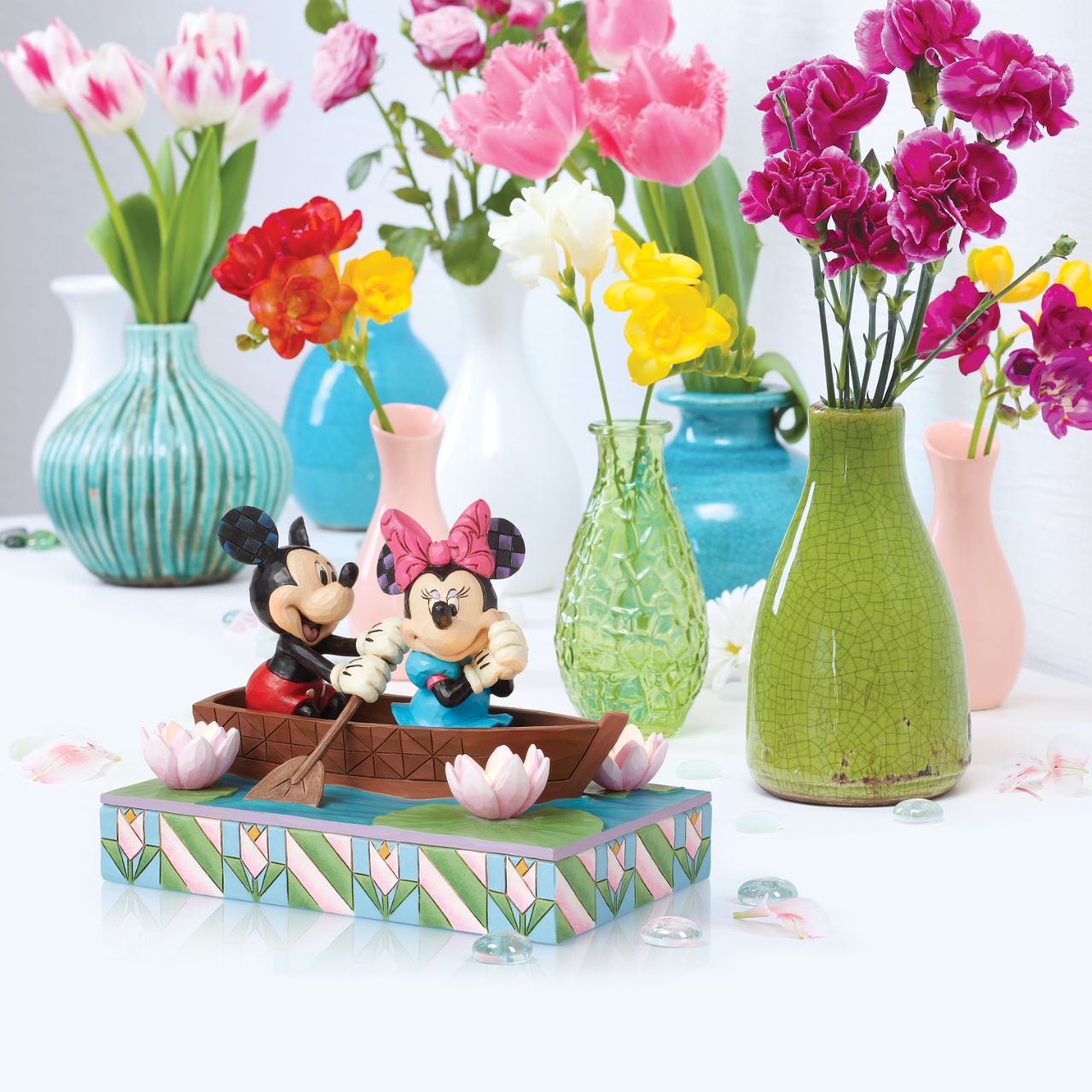 Disneys Mickey and Minnie Mouse are sailing on love in this sweet, light-up figurine from the Disney Traditions by Jim Shore.