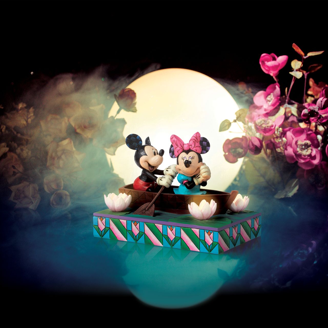 Disneys Mickey and Minnie Mouse are sailing on love in this sweet, light-up figurine from the Disney Traditions by Jim Shore.