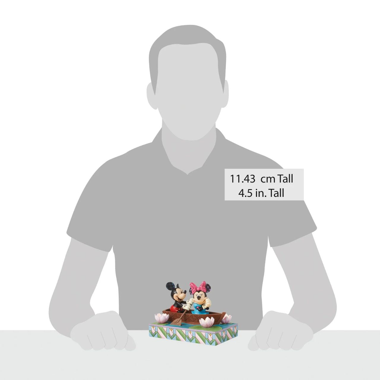 Disneys Mickey and Minnie Mouse are sailing on love in this sweet, light-up figurine from the Disney Traditions by Jim Shore.