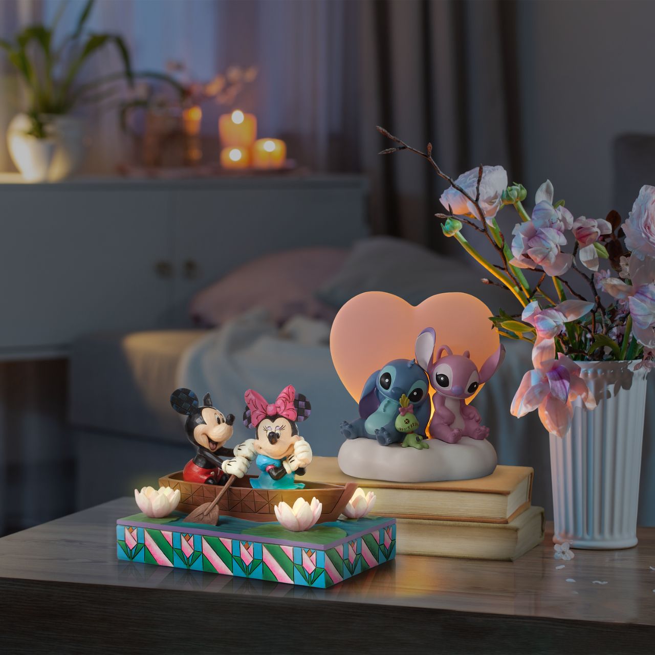 Disneys Mickey and Minnie Mouse are sailing on love in this sweet, light-up figurine from the Disney Traditions by Jim Shore.