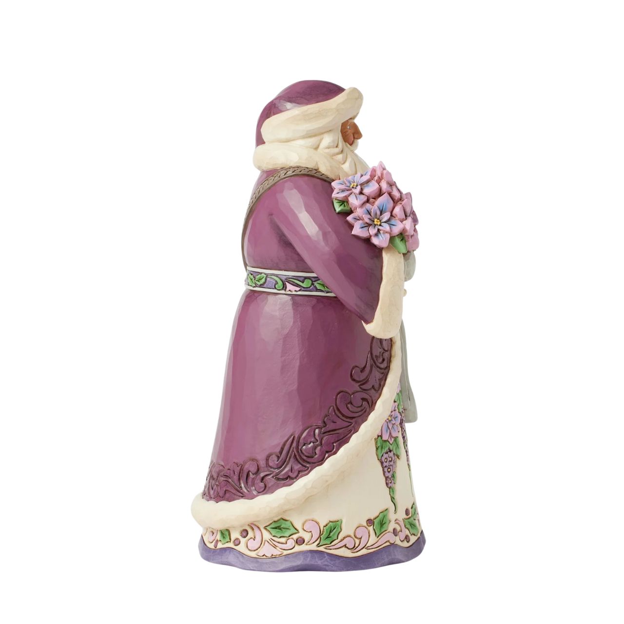 The stunning purple Santa representing Jim Shores trademark colour. Radiating elegance in rich purples, plums, and greens, carrying a vibrant purple poinsettias. His intricately detailed cloak features delicate rosemaling, while his robes bloom with festivities.