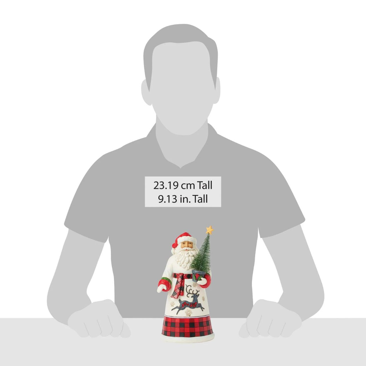 This charming Jim Shore design features Santa holding a decorated sisal tree, dressed in a cosy buffalo plaid cloak that embodies holiday warmth. His gown, adorned with snowflakes and a dashing reindeer silhouette, captures the spirit of the season.