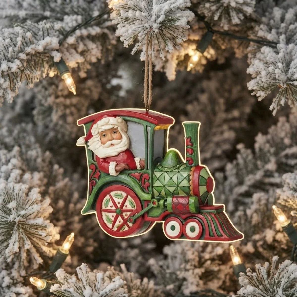 All aboard the Christmas train, next stop, holiday memories! Santa steers this fantastic red and green rosemaling locomotive with mistletoe powered wheels. Hang this stylish train in your tree and admire the creative craftsmanship of Jim Shore.