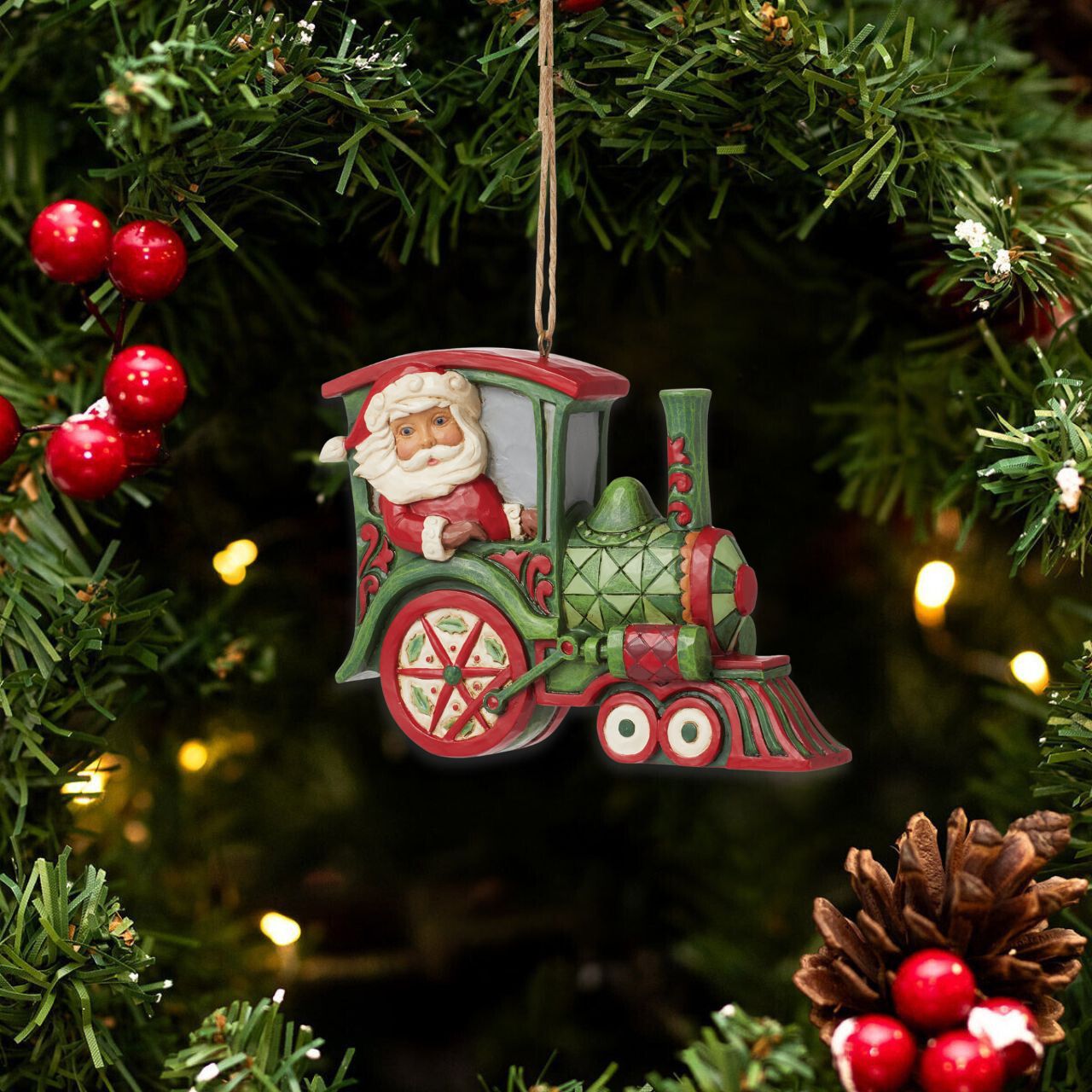 All aboard the Christmas train, next stop, holiday memories! Santa steers this fantastic red and green rosemaling locomotive with mistletoe powered wheels. Hang this stylish train in your tree and admire the creative craftsmanship of Jim Shore.