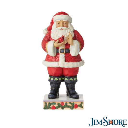 Santa with Cardinal in Hands Figurine Jim Shore  Traditional Heartwood Creek Collection; Wood carved textures and intricately detailed designs. Unique, sometimes surprising combinations of colours - often incorporating a touch of Jim's favourite colour - purple. A very special addition to this years collections of Santa's is this Traditional Santa holding a Cardinal.