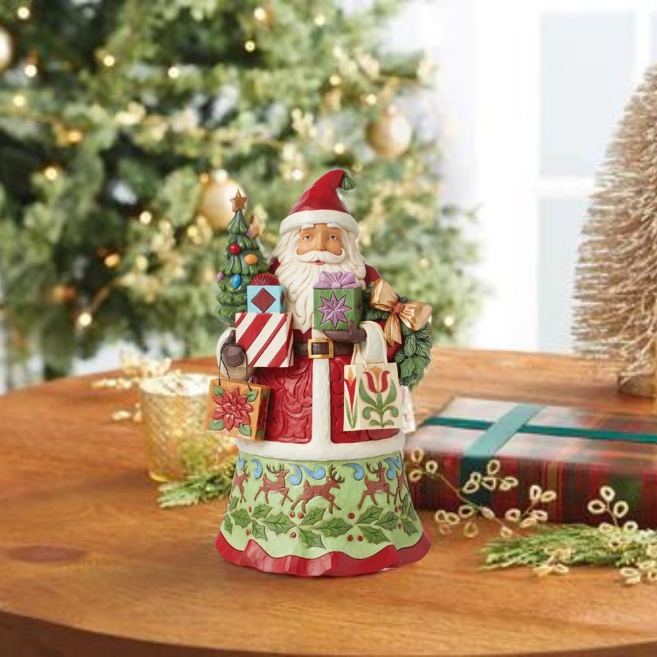 First Edition Signed Figurine - Limited Quantity. Santa is ready to deliver this Christmas. Hand painted, this figurine features Santa with arms full of gifts and is the perfect addition to any festive display.