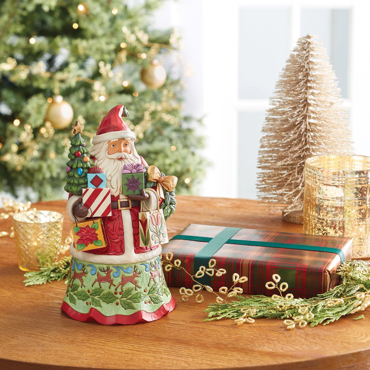 Santa is ready to deliver this Christmas. Hand painted, this figurine features Santa with arms full of gifts and is the perfect addition to any festive display. Comes in fully branded packaging.