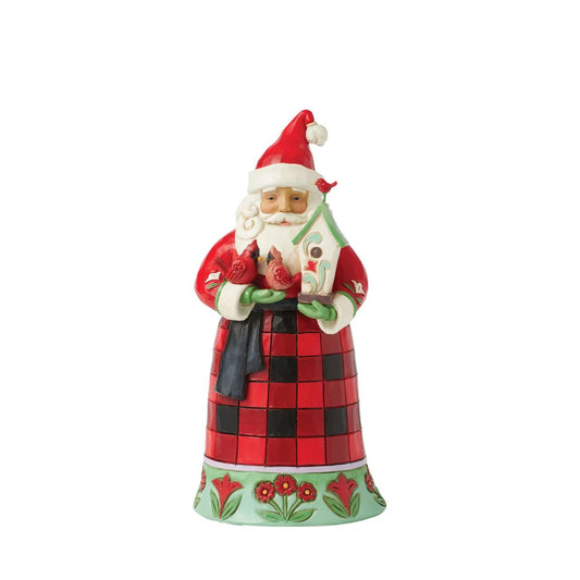 This delightful Jim Shore Highland Glen design features Santa clad in a cozy buffalo plaid cloak beautifully trimmed with floral patterns. Holding a charming birdhouse with two perching cardinals, this piece captures the essence of holiday kindness.