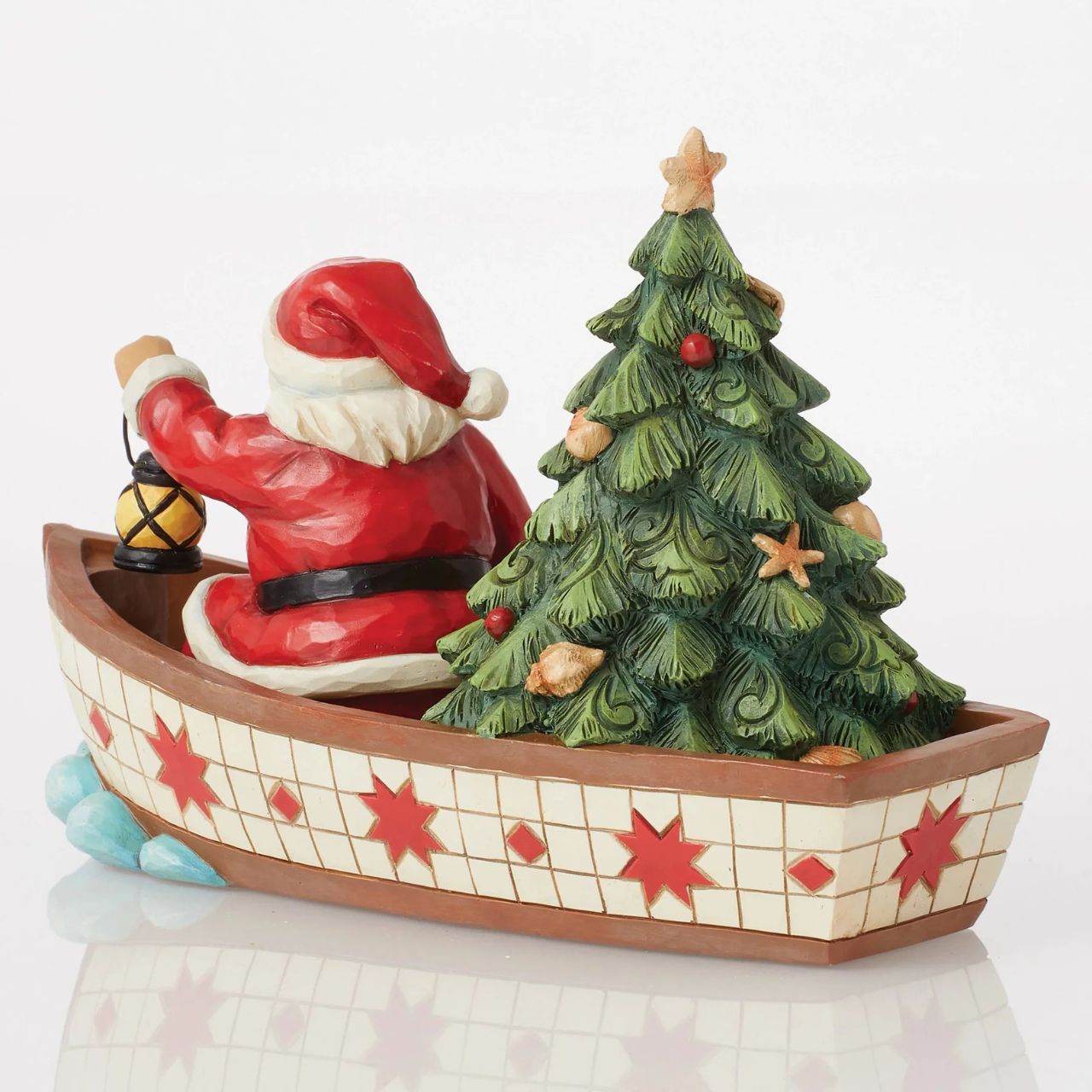 Santa Claus delivers to everywhere in the world. Sometimes he uses other means of transportation than his reindeer sleigh. For coastal deliveries, Santa utilizes a gorgeous red and white boat complete with shell adorned tree and guiding lantern.
