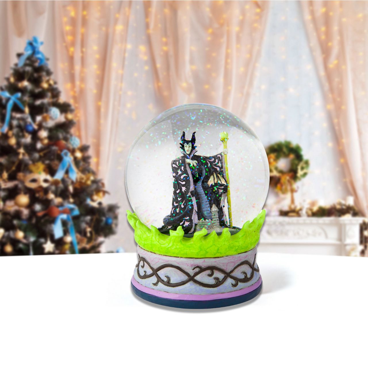 Disney's Sleeping Beauty Maleficent  Christmas Snow Globe  This waterball is almost caldron-like with it's eerie green flames and evil centerpiece. Maleficent, the bitter witch of Disney's Sleeping Beauty, strikes a dubious pose in the water. With immaculate craftsmanship this Jim Shore piece astonishes.