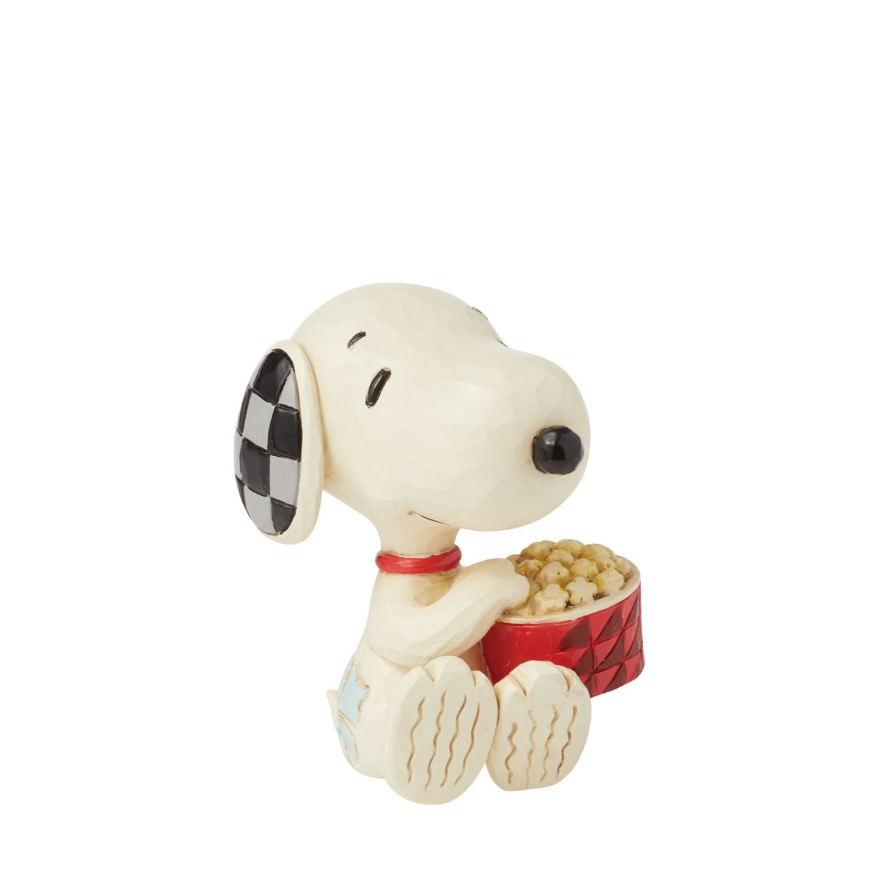 The ever so cheeky Snoopy is having the best time with a large tub of popcorn, ready to watch his favourite film. Mini figurine from the Peanuts collection by Jim Shore. Comes in fully branded packaging.