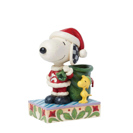Dressed as Santa, Snoopy carries a sculpted bag deep enough to hold real candy canes! With Woodstock by his side, the patterned pair prepare for a holiday spent spreading joy and laughter. Celebrate the season with this Jim Shore Peanuts design.