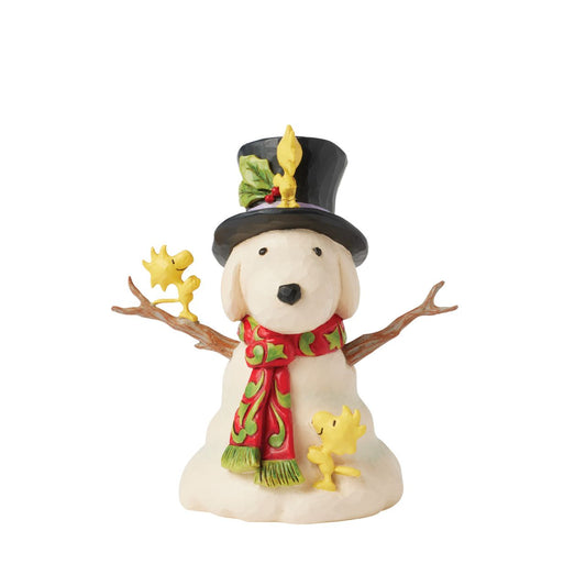 This cheerful creation from Jim Shore shares a scene of Woodstock and his brothers sculpting a snowman in the shape of Snoopy. Modelling their creation after their best friend, the birds lovingly adjust the snowman's hat and rosemale scarf.