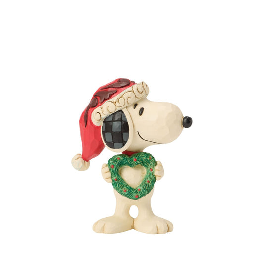 Snoopy holds a heart-shaped wreath in a Santa hat in this darling Jim Shore figurine. Small yet full of holiday charm, it celebrates friendship and Peanuts nostalgia with Christmas warmth.