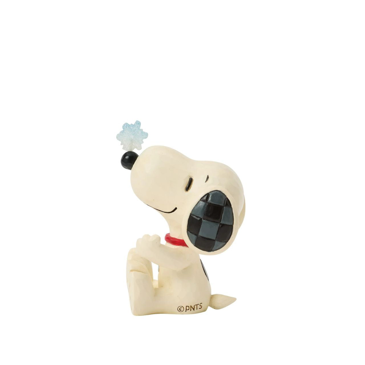 Snoopy balances a delicate snowflake on his nose in this sweet Jim Shore mini. Full of playful charm, it's a whimsical nod to snowy days and the magic of winter. Celebrate your holiday season with the magic of the Peanuts.