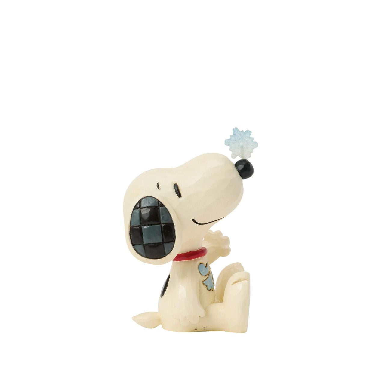 Snoopy balances a delicate snowflake on his nose in this sweet Jim Shore mini. Full of playful charm, it's a whimsical nod to snowy days and the magic of winter. Celebrate your holiday season with the magic of the Peanuts.