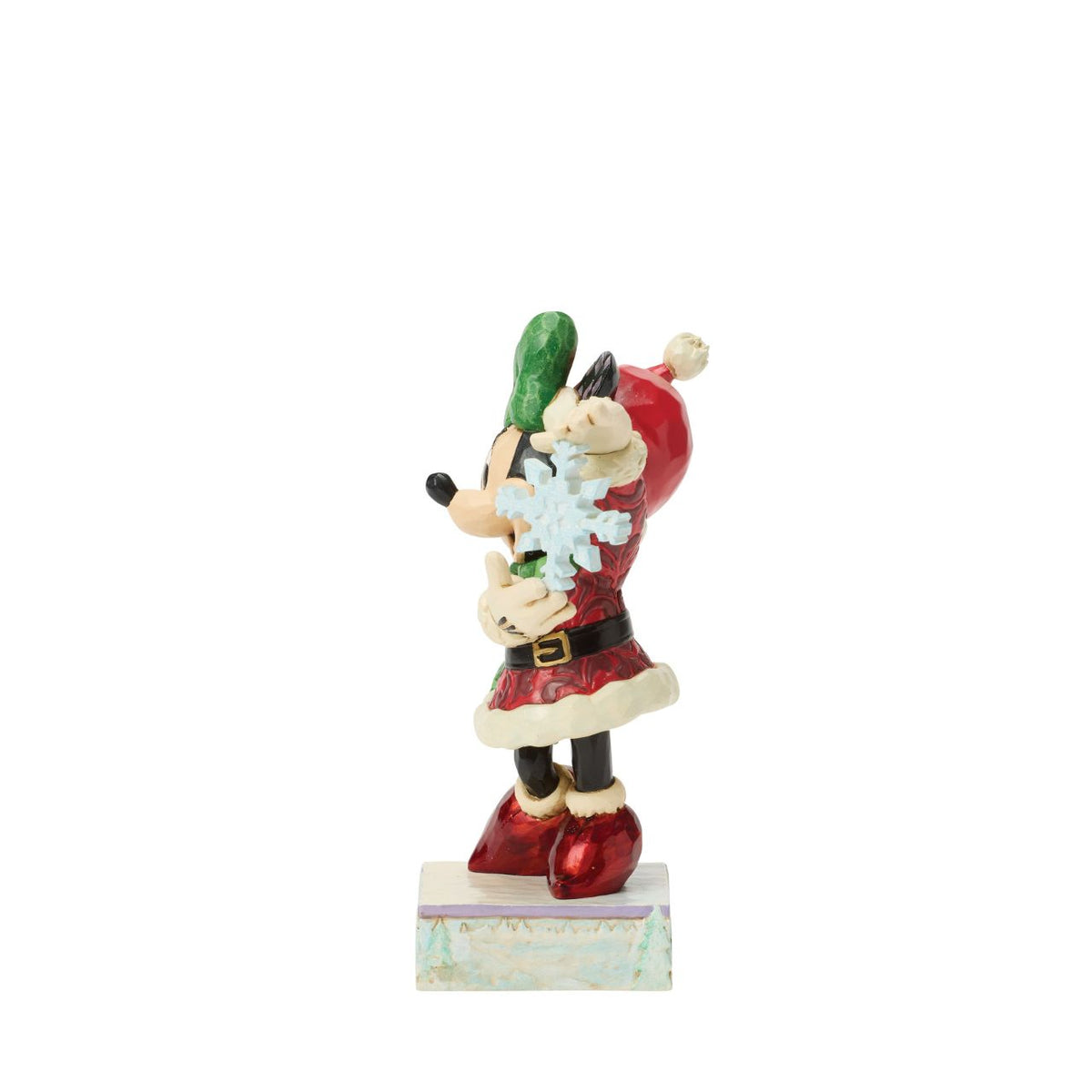 Minnie Mouse sparkles in holiday style as she holds a delicate snowflake in this Jim Shore masterpiece.