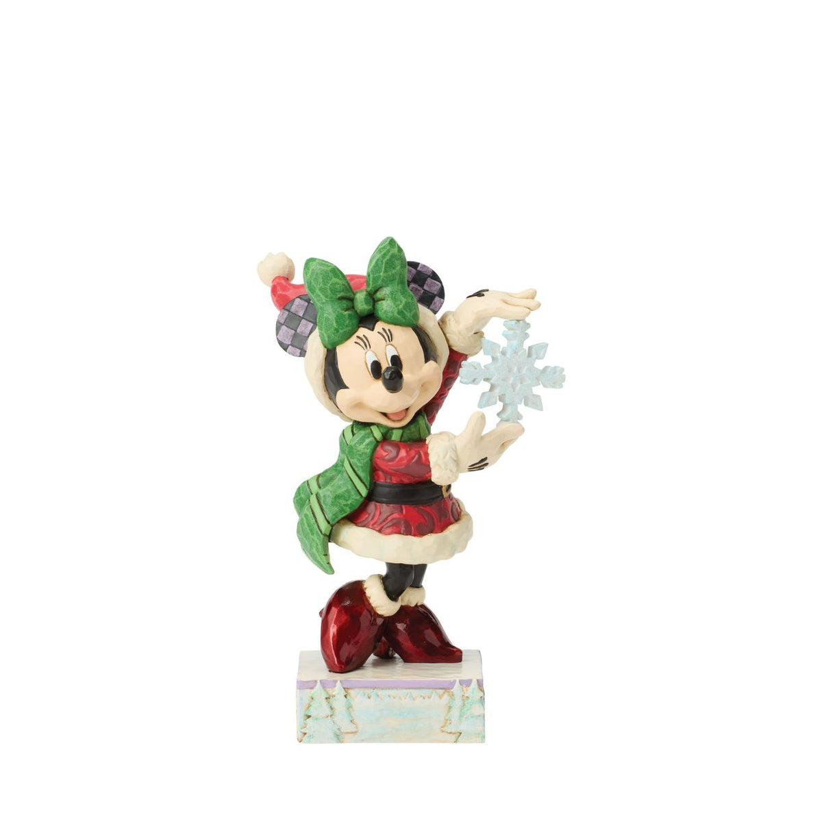 Minnie Mouse sparkles in holiday style as she holds a delicate snowflake in this Jim Shore masterpiece.