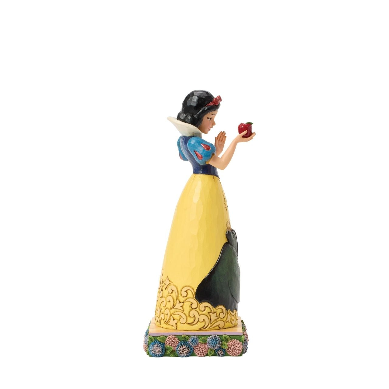Snow White's story is told upon her gown in this sculpted scene from the creative mind of Jim Shore.
