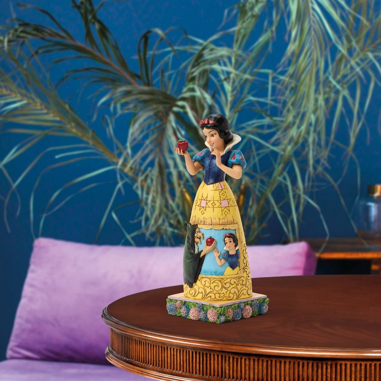 Snow White's story is told upon her gown in this sculpted scene from the creative mind of Jim Shore.