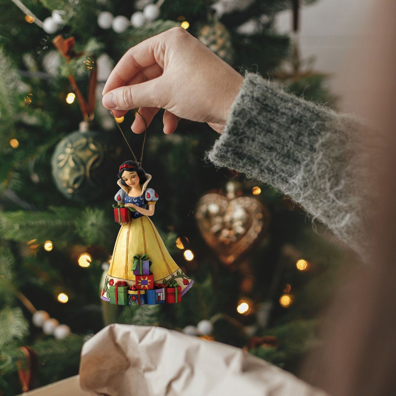 Disney Traditions combines the magic of Disney with the festive artistry of Jim Shore. This Snow White cast stone hanging ornament is sure to add Disney's magic to your Christmas tree. Unique variations should be expected as this product is hand painted. Packed in a branded gift box. Not a toy or children's product. Intended for adults only.