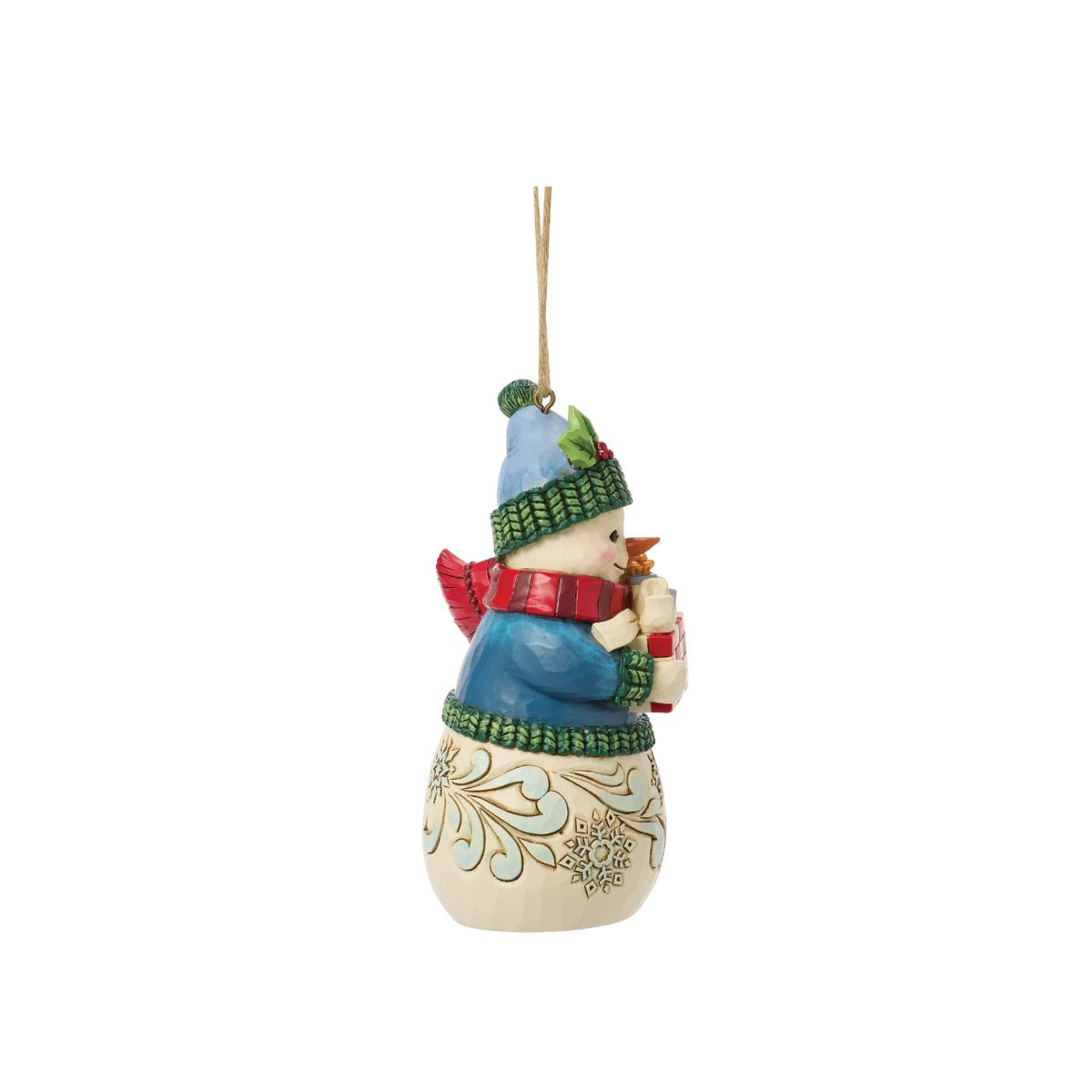 Celebrate the magic of Christmas with this delightful Snowman Figurine from Heartwood Creek by Jim Shore. This endearing snowman is depicted carrying an abundance of holiday treasures, showcasing Jim Shore's signature folk-art style with intricate patterns and a warm colour palette.
