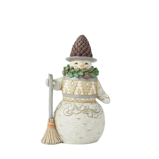This cheerful Jim Shore designed snowman carrying a broomstick, sure is exuding charm with a wreath wrapped around his neck as a scarf and a pinecone hat. His delightful details capture the beauty of winter and the joy of the season.