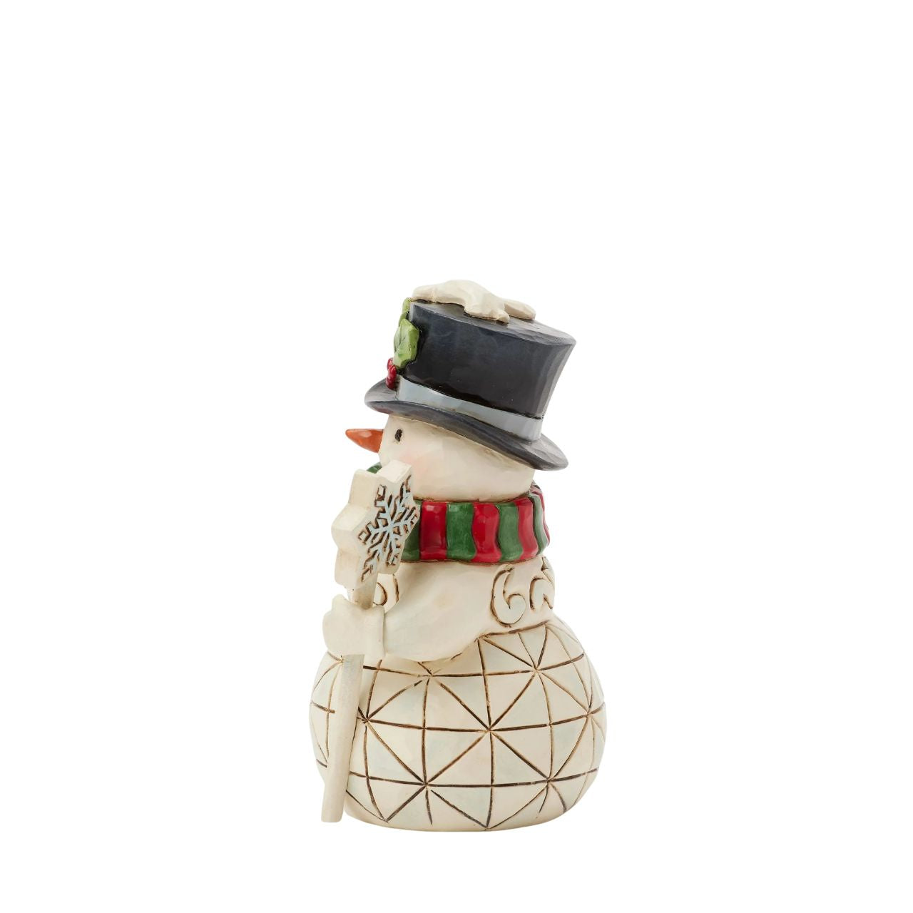 This delightful Jim Shore miniature snowman brings holiday cheer with a snowflake-topped cane and a festive red and green. His charming top hat, adorned with holly and dusted with snow, makes him a joyful addition to your holiday home.