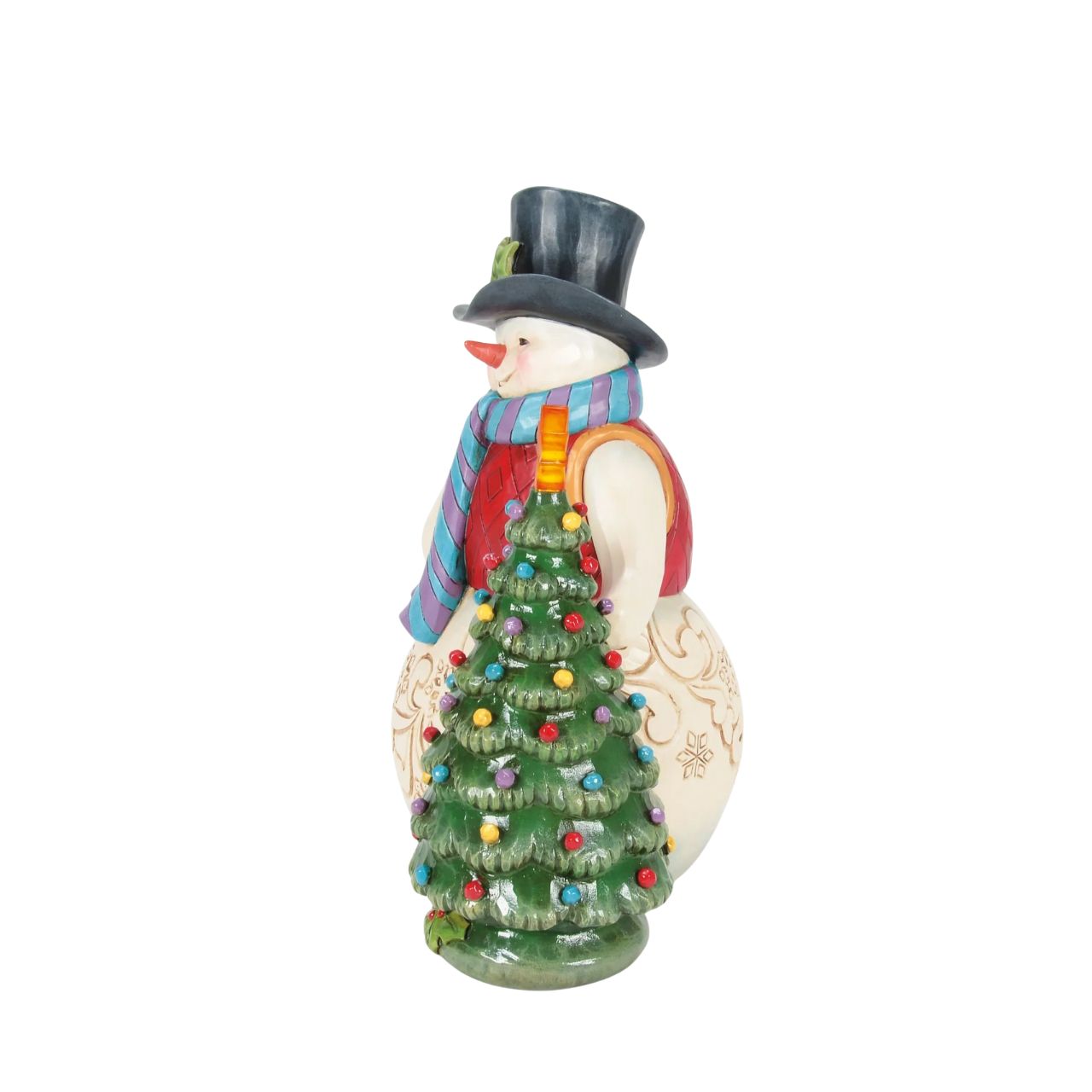 This enchanting Jim Shore snowman, dressed in a gorgeous tunic, scarf, and holly-brimmed top hat, stands beside a decorated Christmas tree and the star lights up. Adorned with snowflakes and rosemaling, he brings a vintage warmth to your holiday home.