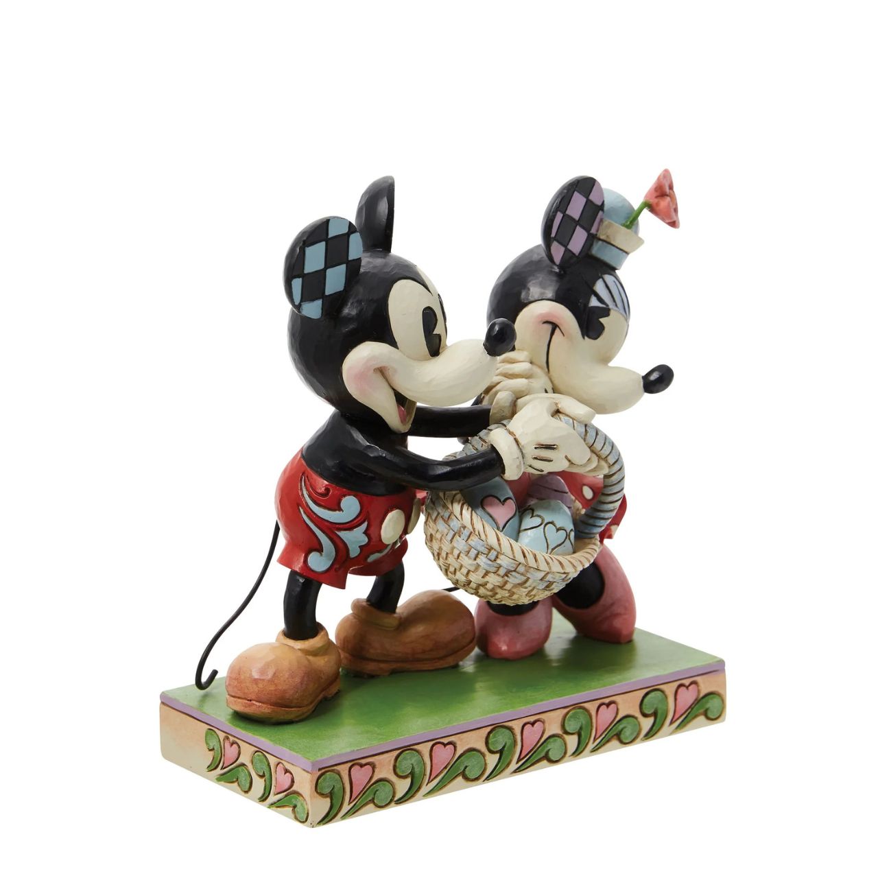 Celebrate the magic of Easter with the vintage-style Mickey and Minnie Mouse figurine from Disney Traditions by Jim Shore. These "Springtime Sweethearts" are depicted holding an Easter basket filled with vibrant coloured eggs, capturing the essence of springtime traditions.