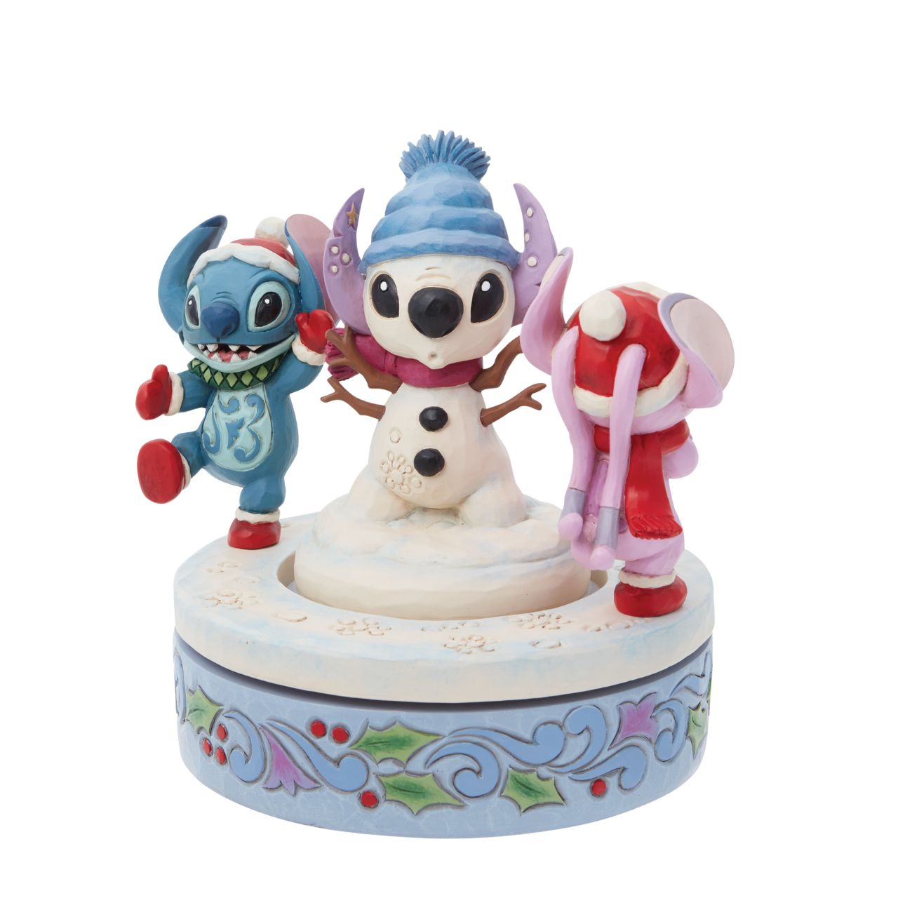 Disney Stitch & Angel Rotating Figurine by Jim Shore  Disney's Stitch and Angel are playing in the snow with their extra special Snowman this Christmas. Hand rotatable, they chase each other round and round. Designed by award winning artist Jim Shore, hand crafted from high quality cast stone and hand painted.