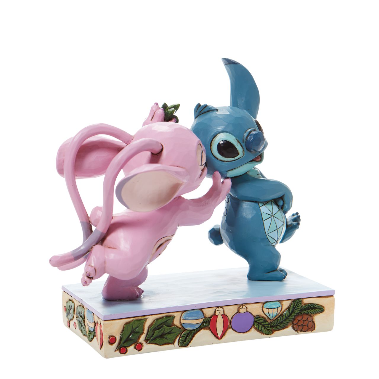 Disney Stitch and Angel with Mistletoe Figurine - Mistletoe Kiss  Stitch the holiday hooligan meets his match under the mistletoe this season. The pair of mischievous aliens share a smooch in this sweet Jim Shore figurine. Colourfully lined in ornaments, the pair make a lovely addition to any home - even on Earth.