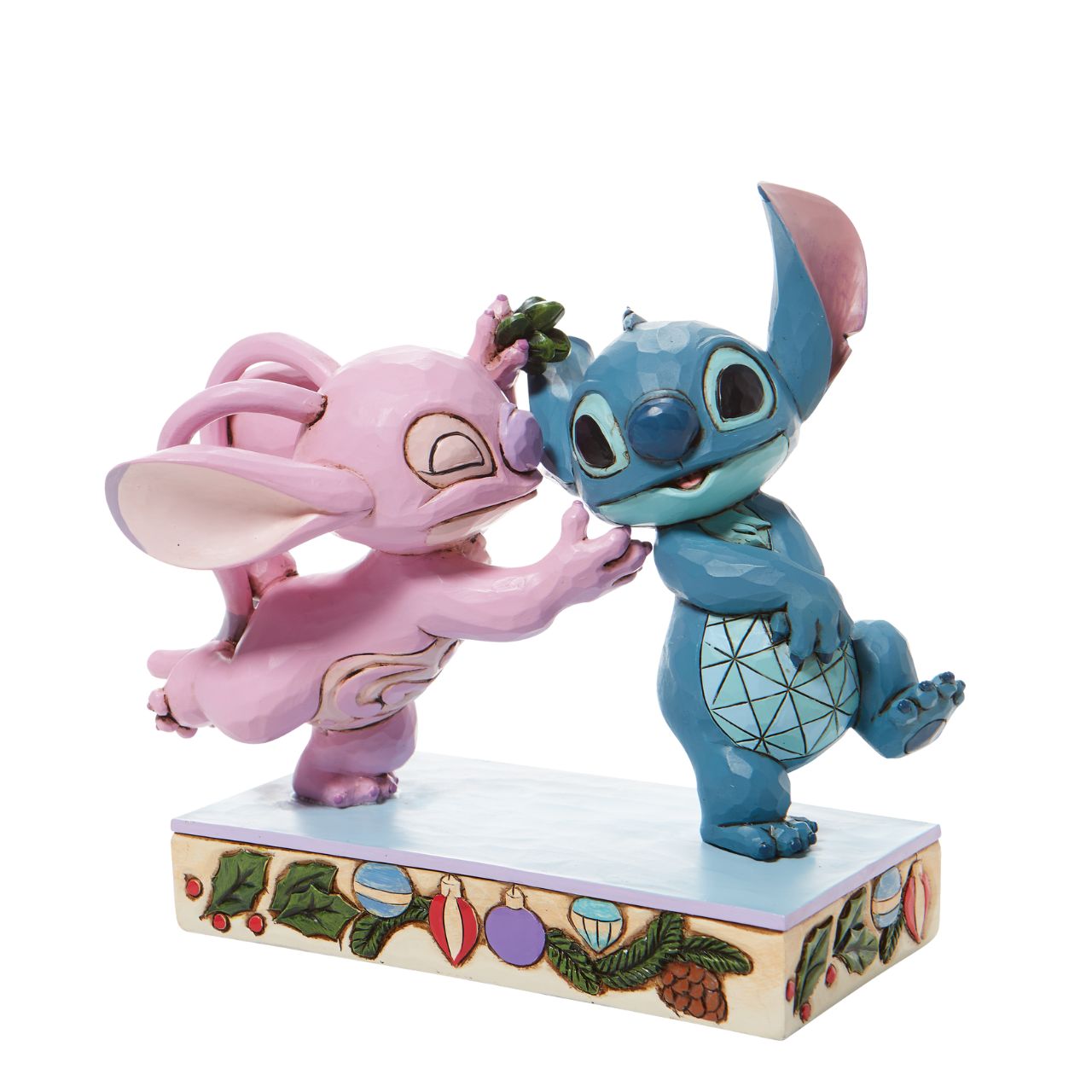 Disney Stitch and Angel with Mistletoe Figurine - Mistletoe Kiss  Stitch the holiday hooligan meets his match under the mistletoe this season. The pair of mischievous aliens share a smooch in this sweet Jim Shore figurine. Colourfully lined in ornaments, the pair make a lovely addition to any home - even on Earth.