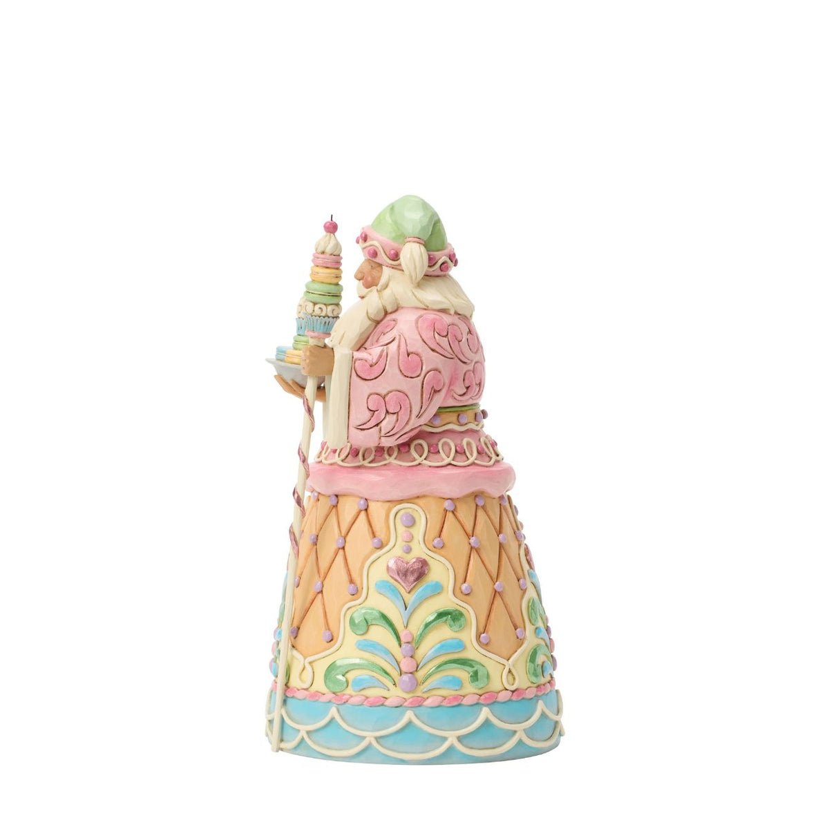Dressed in candy-coloured pastels, this gingerbread Santa holds a macaron-topped staff. Jim Shore's intricate detailing and soft hues give this piece a magical, storybook quality. A deliciously different take on Santa's classic look.