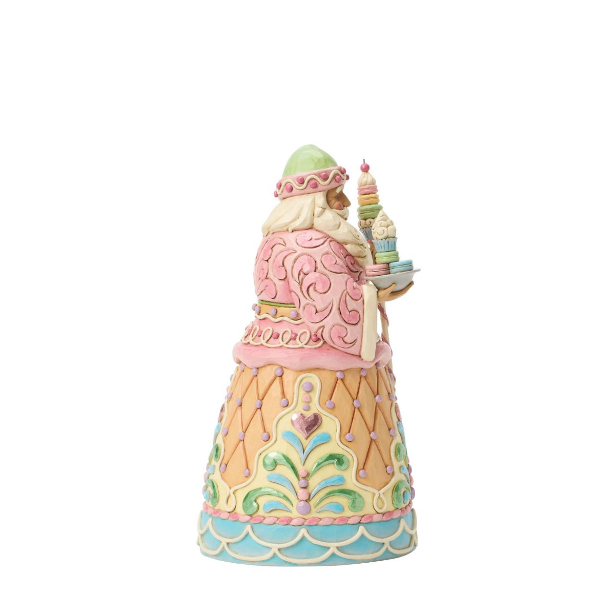 Dressed in candy-coloured pastels, this gingerbread Santa holds a macaron-topped staff. Jim Shore's intricate detailing and soft hues give this piece a magical, storybook quality. A deliciously different take on Santa's classic look.
