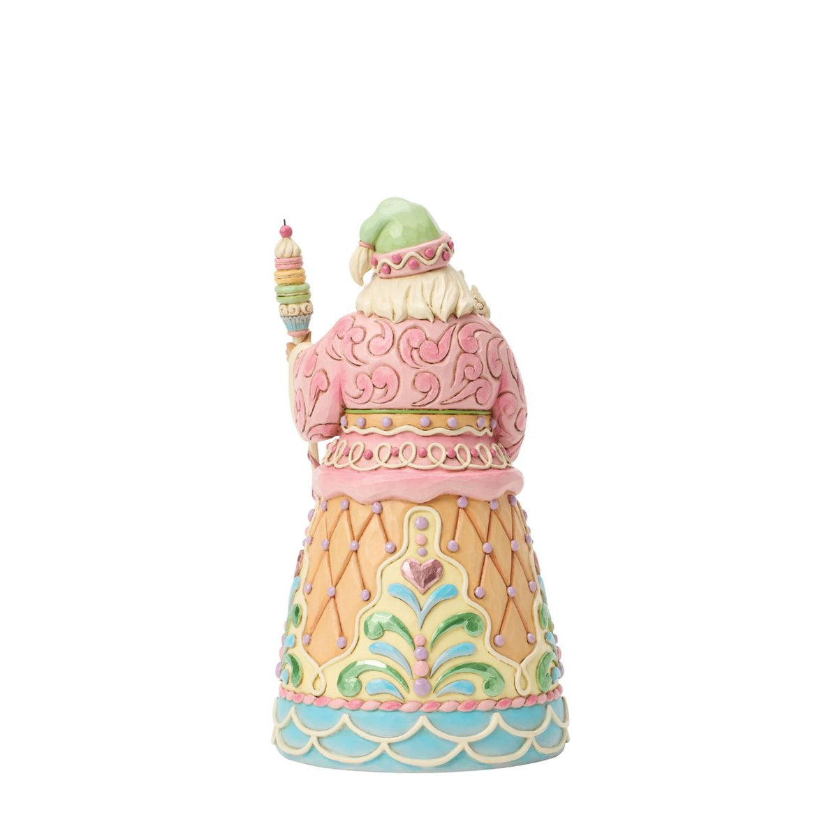 Dressed in candy-coloured pastels, this gingerbread Santa holds a macaron-topped staff. Jim Shore's intricate detailing and soft hues give this piece a magical, storybook quality. A deliciously different take on Santa's classic look.