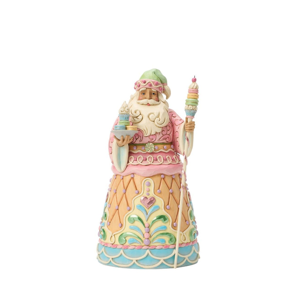 Dressed in candy-coloured pastels, this gingerbread Santa holds a macaron-topped staff. Jim Shore's intricate detailing and soft hues give this piece a magical, storybook quality. A deliciously different take on Santa's classic look.