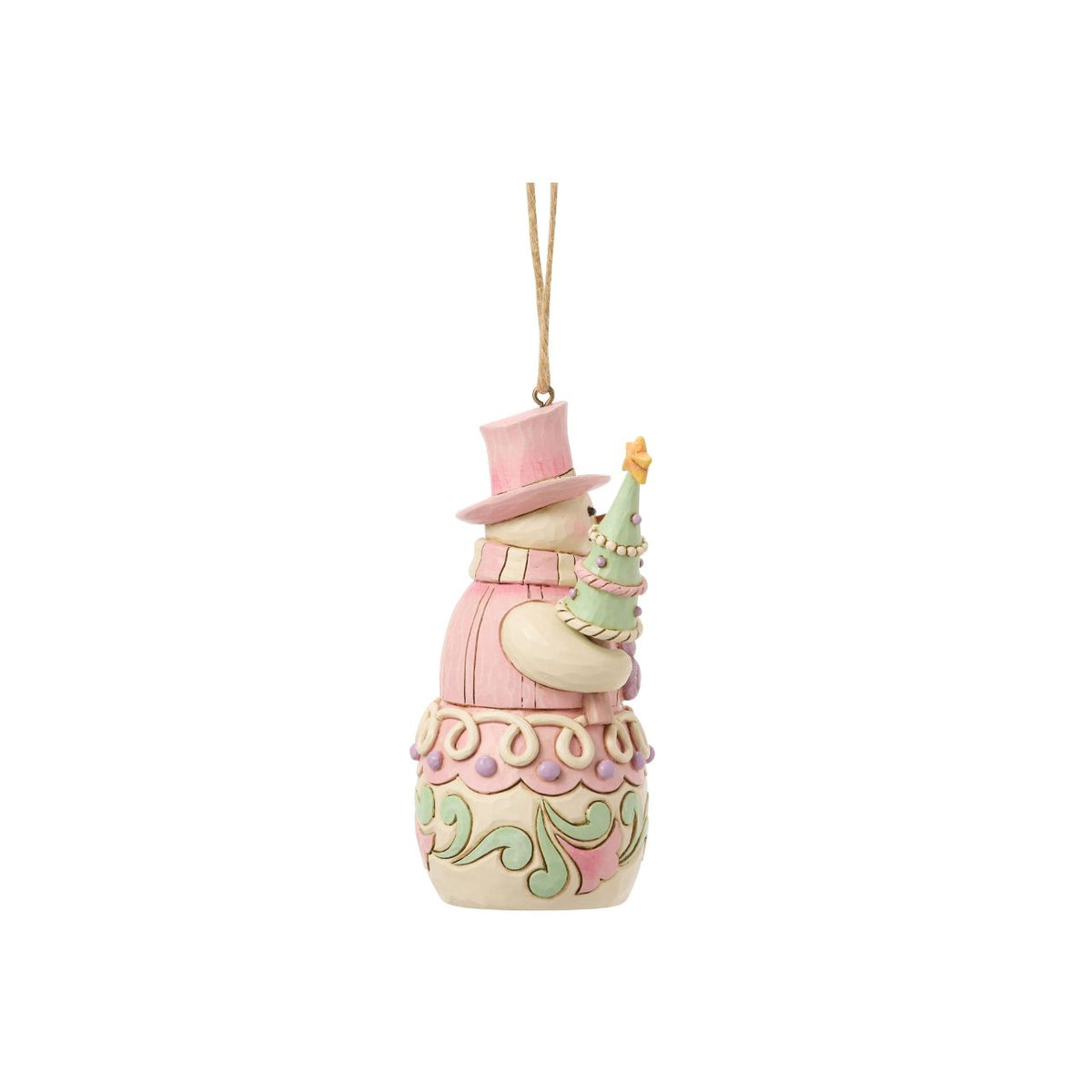 Bundled up for the season, this snowman ornament carries a decorated Christmas tree in his arms. Jim Shore's intricate designs swirl across his coat, adding heart-warming detail to this classic winter character. A joyful symbol of holiday sweetness.
