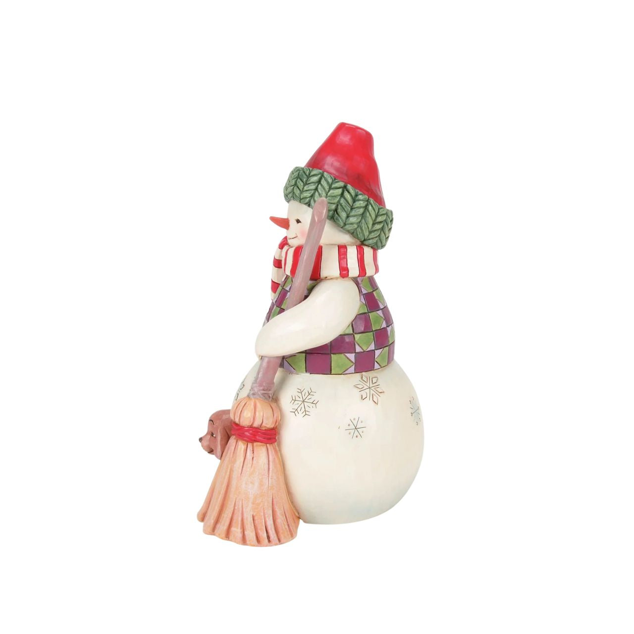 This Jim Shore snowman is dressed in a patterned tunic and holds a broom, and is accompanied by a precious pup peeking out with an excitable spirit. Together, they embody the joy of the season, spreading smiles and warmth through the snowy landscape.