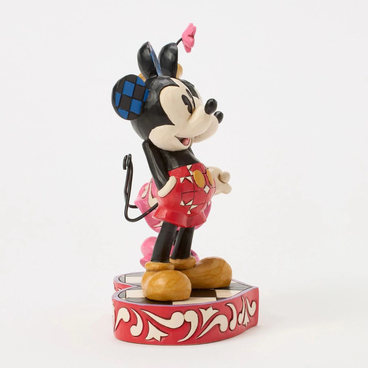 This romantic Disney design by Jim Shore features Mickey and Minnie Mouse, adorned with rosemaling and patchwork details. They stand on a heart-shaped base radiating the warmth of their timeless affection.