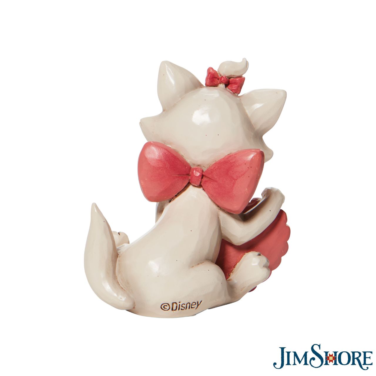 Jim Shore The Aristocats Marie Heart Mini Figurine  The 1970 Walt Disney classic, The Aristocats, followed three kittens and their mother across the Parisian countryside after being cat-napped from their home. Marie, the only daughter of the bunch, holds a pink heart in this sweet Jim Shore figurine. Packaged in a branded gift box.
