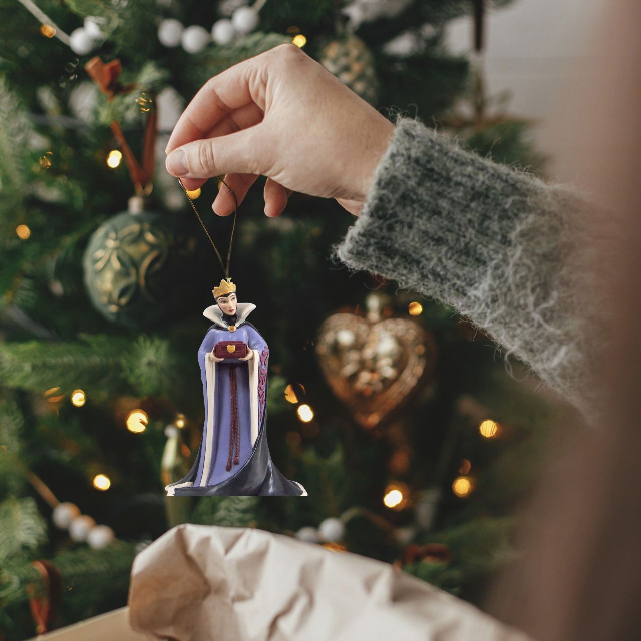 The Evil Queen from Disney's first feature length film "Snow White and the Seven Dwarfs" has been hand crafted into a hanging ornament, perfect to add a little bit of villainy to your Christmas tree.