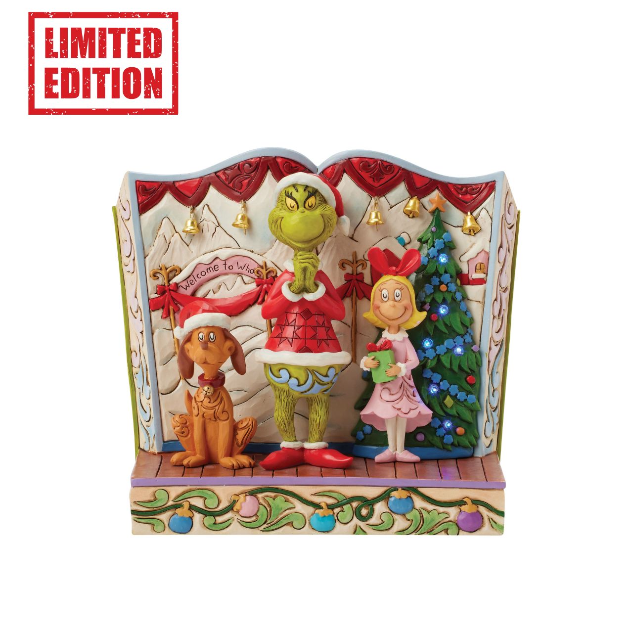 Framed within the classic Dr. Seuss book, this Jim Shore piece captures The Grinch's heartwarming transformation with Cindy Lou and Max by his side. Dressed as Santa, he smiles with rosemaling, patchwork patterns, and real jingle bell details.