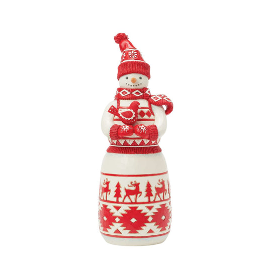 This sweet Jim Shore Nordic Noel snowman features bold red Nordic-inspired patterns, on his body, gloves, cosy scarf, and knitted hat. Holding a delicate cardinal bird in his hands, the snowman boasts whimsical trees and reindeer with a loving smile.