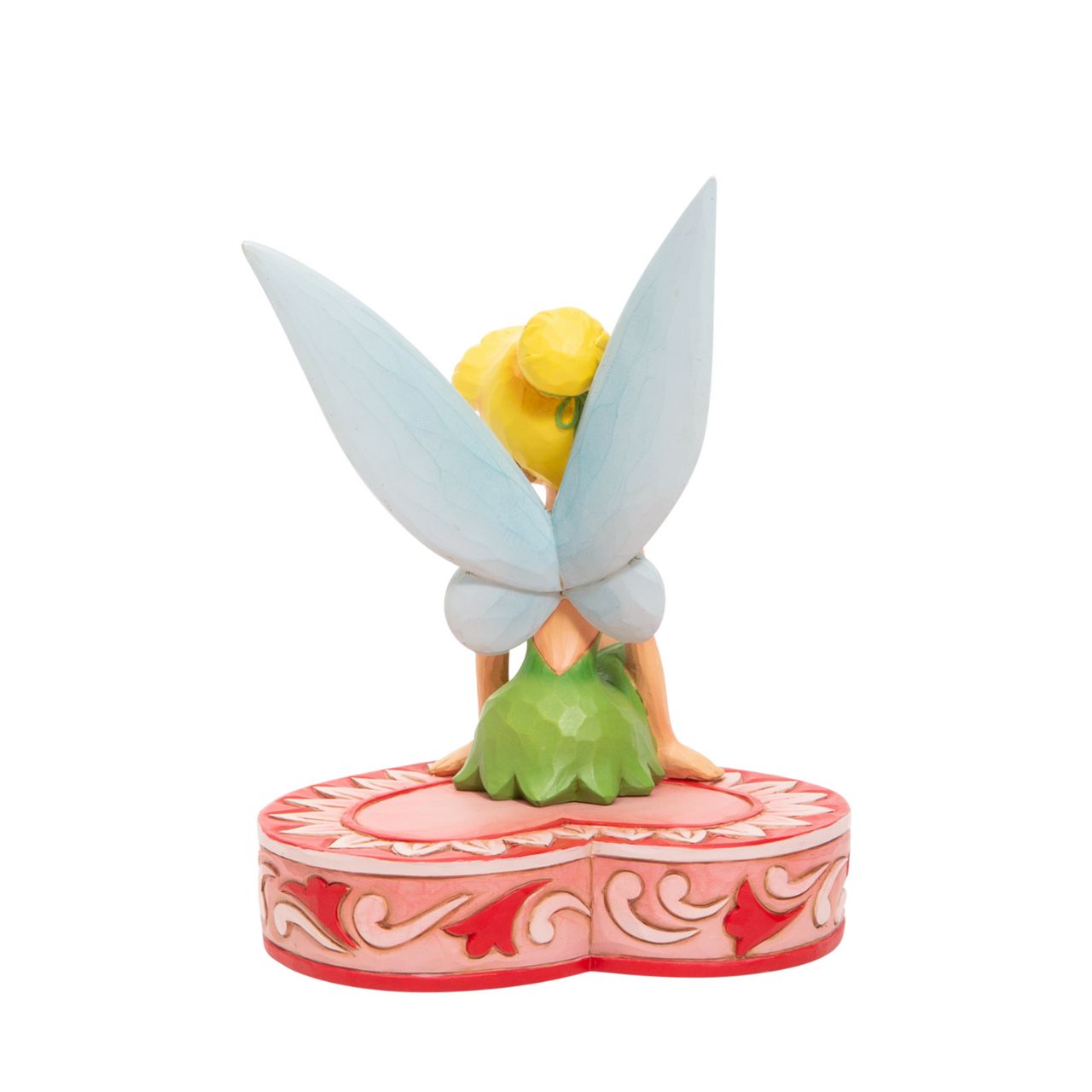 This fairy is sweeter than candy and sits on a heart-shaped box in this Jim Shore collectible. Tinkerbell, Peter Pan's sassy sidekick smiles coquettishly legs crossed daintily. With delicate rosemaling this fairy is in the love seat. Unique variations should be expected as this product is hand painted.