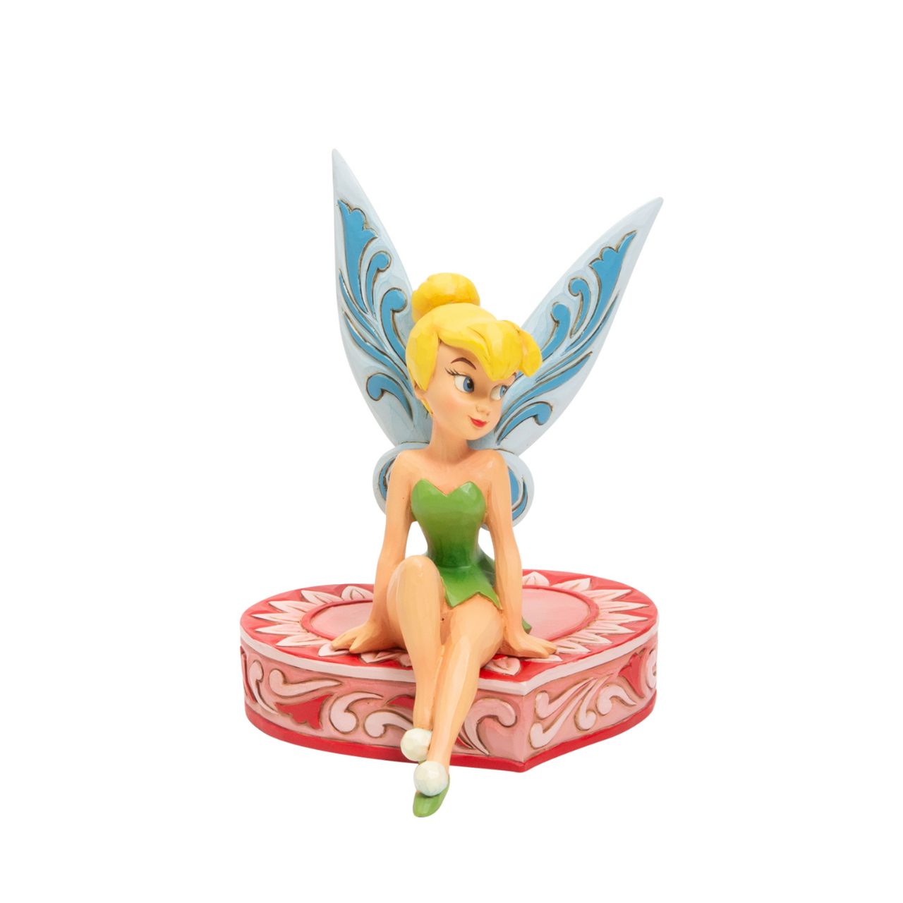 This fairy is sweeter than candy and sits on a heart-shaped box in this Jim Shore collectible. Tinkerbell, Peter Pan's sassy sidekick smiles coquettishly legs crossed daintily. With delicate rosemaling this fairy is in the love seat. Unique variations should be expected as this product is hand painted.