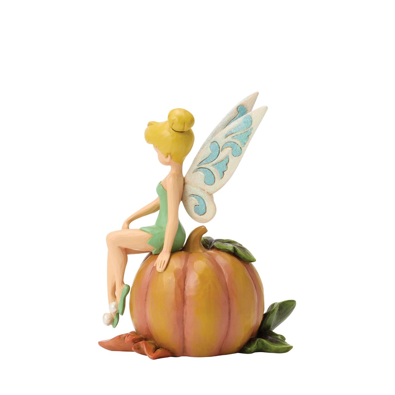 Tinker Bell adds a touch of pixie dust to Halloween magic in this charming Jim Shore design. Dressed in festive autumn colours, she sits gracefully on a pumpkin, blending Disney whimsy with folk-art charm.