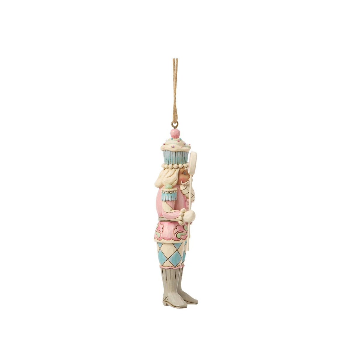 A playful twist on tradition, this toy soldier holds a bright candy lollipop and wears a cupcake helmet. Jim Shore's artistry transforms the disciplined officer into a whimsical holiday friend. Perfect for sweetening any Christmas display.